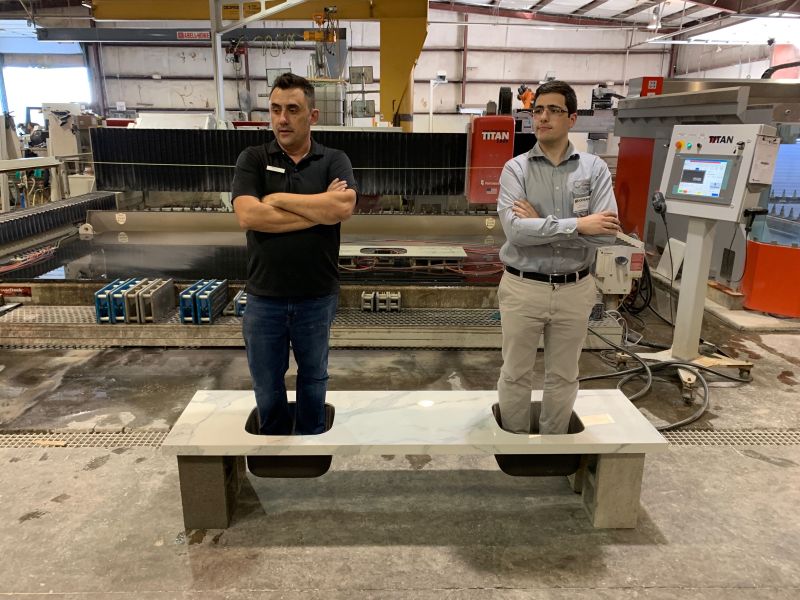 Two men standing in undermount sinks supported by Keep-Nut anchors during a load demonstration