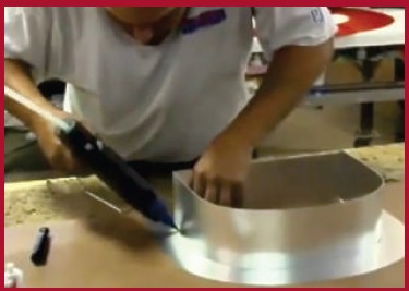 Tacking a channel letter return to the face with the CCH220 hot melt gun